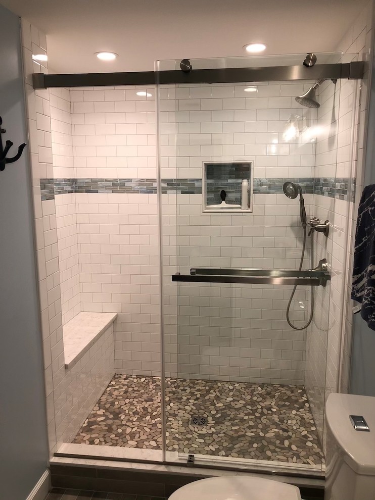 Inspiration for a mid-sized transitional 3/4 white tile and ceramic tile porcelain tile and gray floor sliding shower door remodel in New York with blue walls