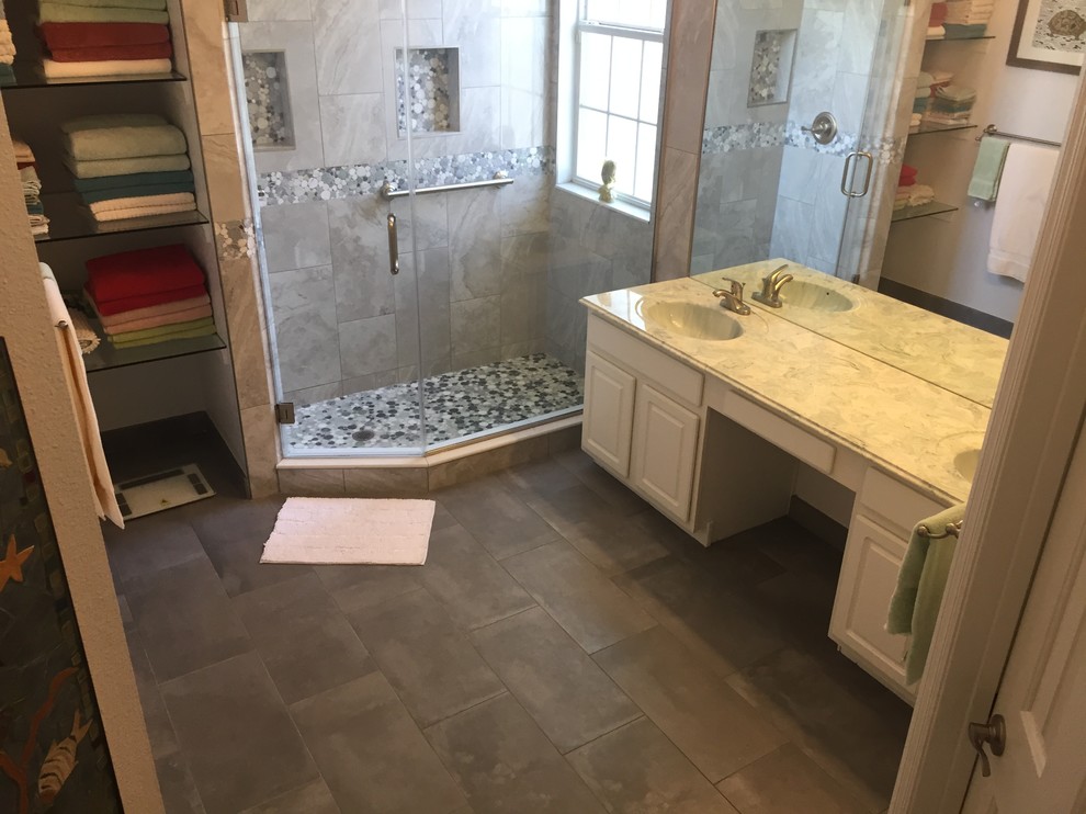 Example of a small classic 3/4 black and white tile, gray tile and porcelain tile porcelain tile and gray floor alcove shower design in Orlando with raised-panel cabinets, white cabinets, white walls, an integrated sink, quartz countertops and a hinged shower door