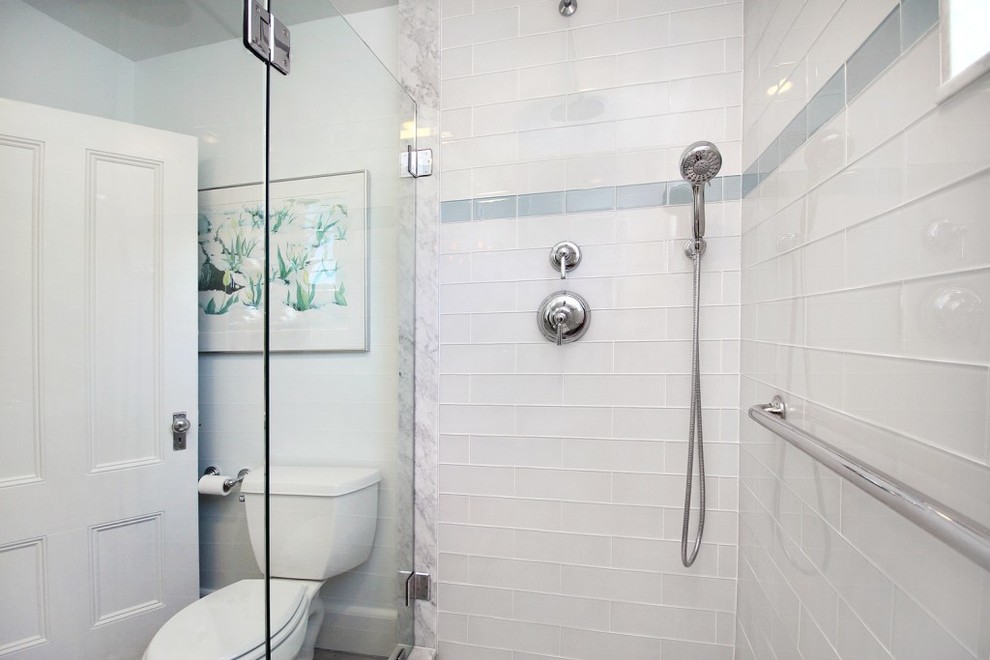 Design ideas for a medium sized modern ensuite bathroom in Providence with freestanding cabinets, white cabinets, an alcove shower, a two-piece toilet, white tiles, metro tiles, white walls, ceramic flooring, a built-in sink and marble worktops.