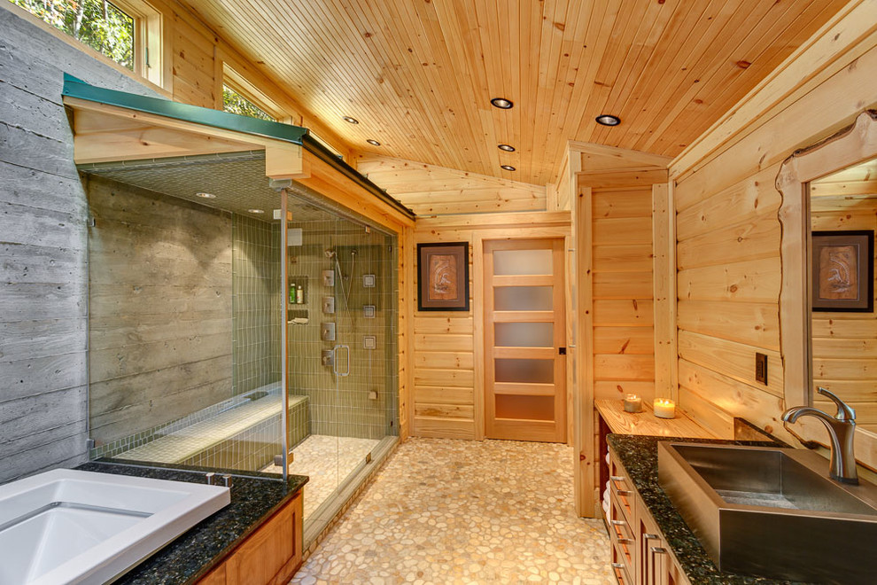 Esempio di una stanza da bagno stile rurale di medie dimensioni con lavabo a bacinella, ante in stile shaker, ante in legno scuro, vasca da incasso, doccia ad angolo e pavimento con piastrelle di ciottoli
