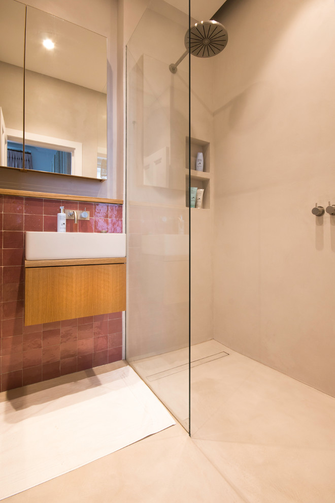 Large shabby-chic style shower room bathroom in London with freestanding cabinets, brown cabinets, a walk-in shower, a wall mounted toilet, brown tiles, terracotta tiles, beige walls, a wall-mounted sink, wooden worktops, beige floors and an open shower.