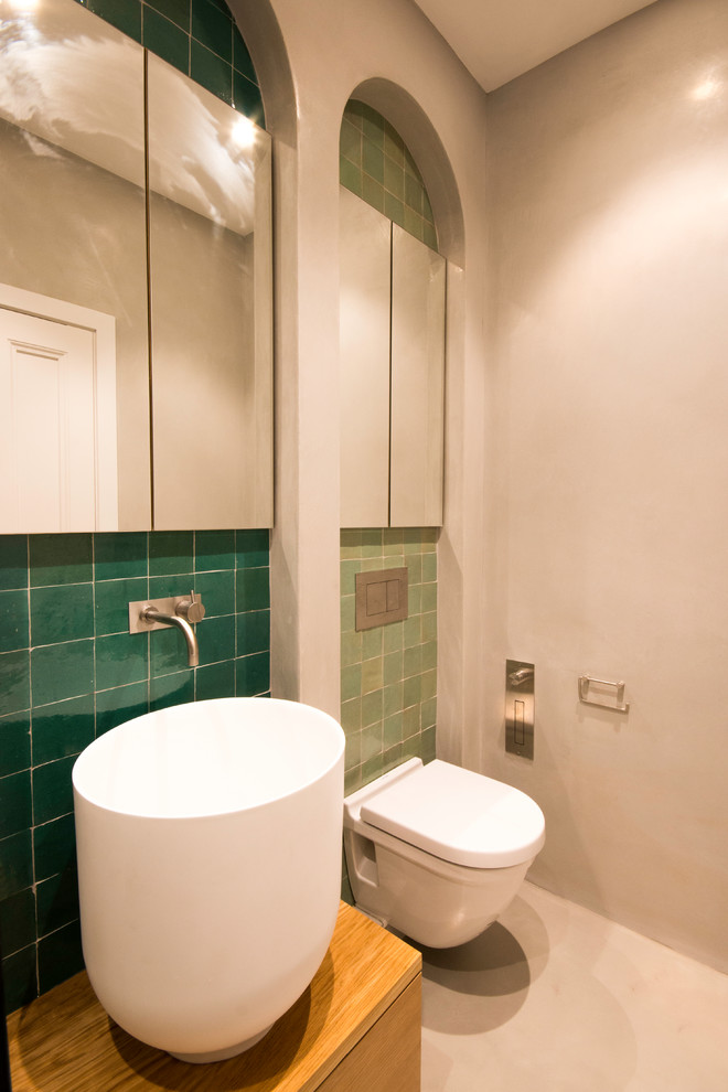 This is an example of a large shabby-chic style shower room bathroom in London with freestanding cabinets, brown cabinets, a freestanding bath, a walk-in shower, a wall mounted toilet, brown tiles, terracotta tiles, beige walls, a wall-mounted sink, wooden worktops, beige floors and an open shower.