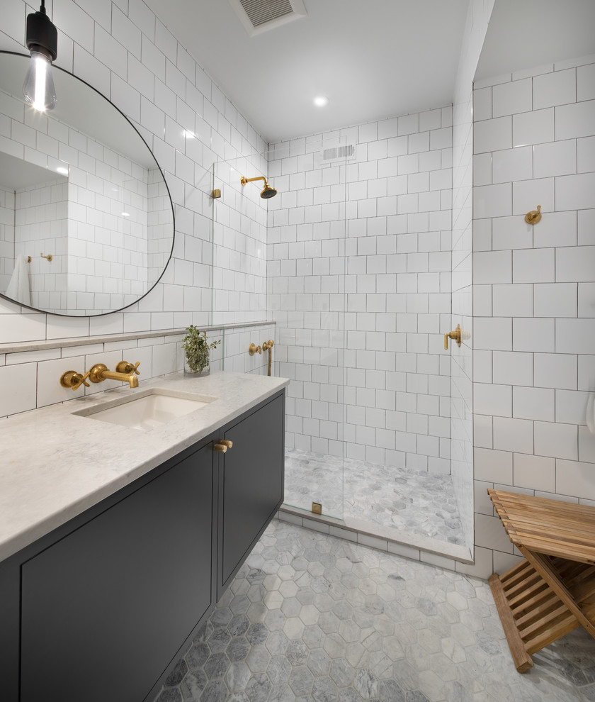 Inspiration for a medium sized contemporary shower room bathroom in DC Metro with beaded cabinets, black cabinets, an alcove shower, a wall mounted toilet, white tiles, metro tiles, white walls, mosaic tile flooring, a submerged sink, engineered stone worktops, grey floors, an open shower and beige worktops.