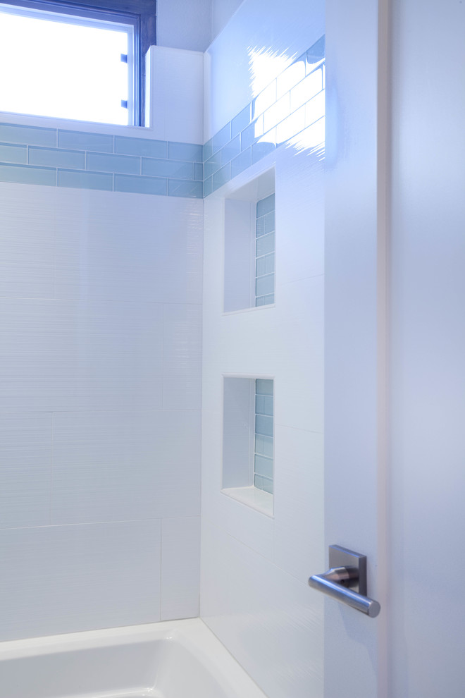 Example of a mid-sized kids' white tile and porcelain tile porcelain tile and white floor bathroom design in San Diego with flat-panel cabinets, blue cabinets, a one-piece toilet, gray walls, a trough sink and quartz countertops