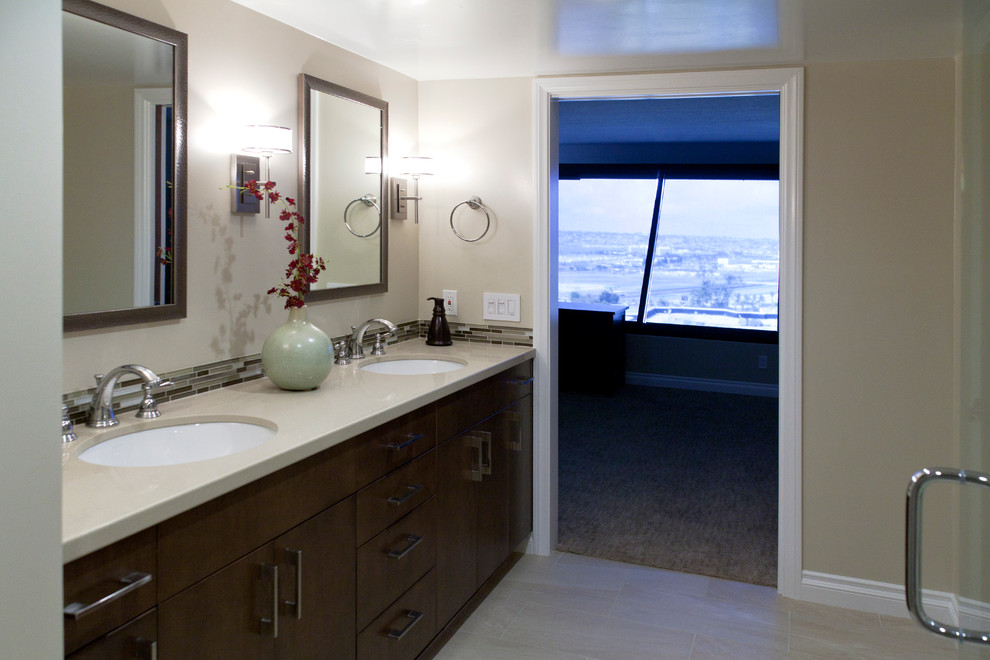 Trendy beige floor and double-sink bathroom photo in San Diego with brown cabinets, beige walls and beige countertops