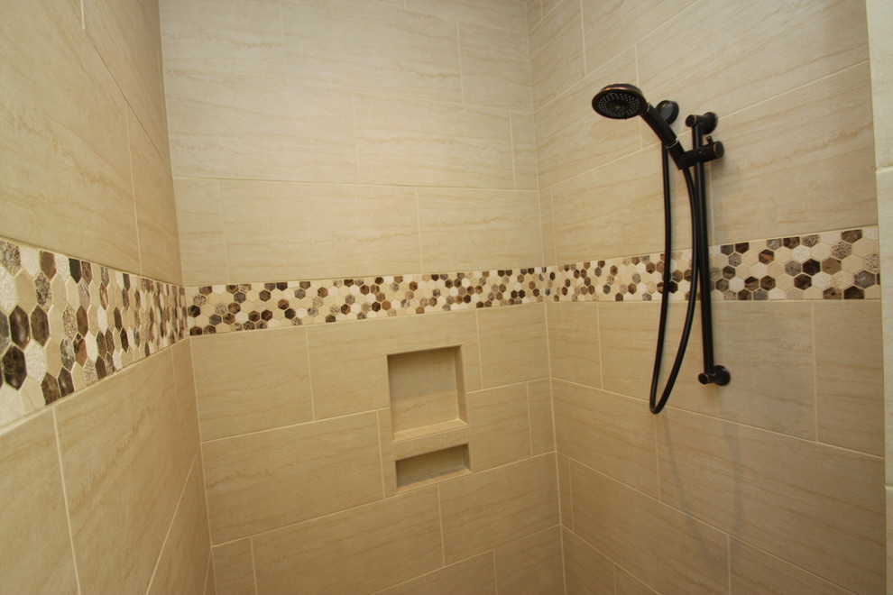 Design ideas for a medium sized classic shower room bathroom in Raleigh with raised-panel cabinets, dark wood cabinets, an alcove shower, a two-piece toilet, beige tiles, ceramic tiles, beige walls, dark hardwood flooring, a submerged sink, limestone worktops, brown floors and a hinged door.
