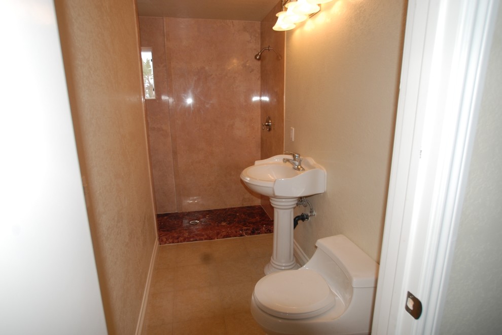 Example of a mid-sized minimalist master beige tile and stone slab porcelain tile alcove shower design in Orange County with a pedestal sink, a one-piece toilet and beige walls