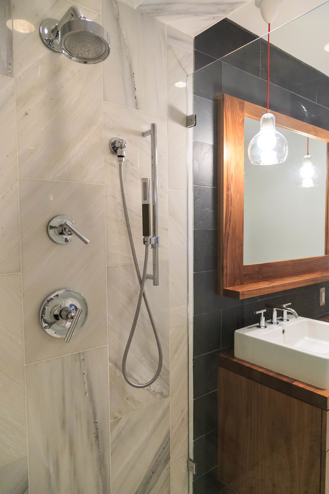 Inspiration for a large contemporary ensuite bathroom in Minneapolis with flat-panel cabinets, a built-in bath, a walk-in shower, black walls, a pedestal sink, medium wood cabinets, a one-piece toilet, marble tiles, porcelain flooring, wooden worktops, white floors and a hinged door.