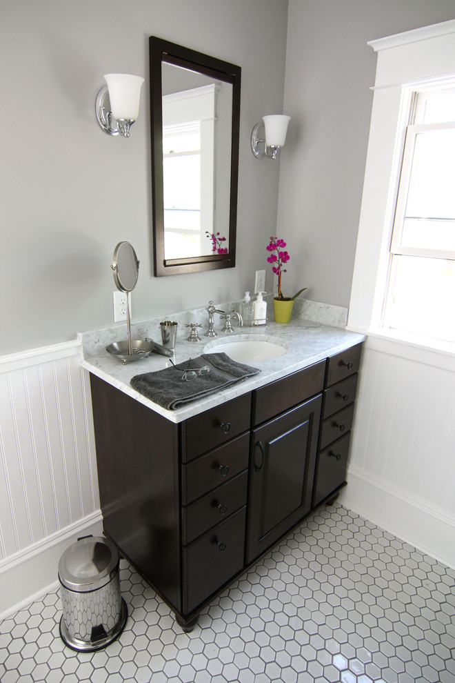 Inspiration for a mid-sized timeless white tile and ceramic tile ceramic tile bathroom remodel in Minneapolis with raised-panel cabinets, dark wood cabinets, gray walls, an undermount sink and marble countertops