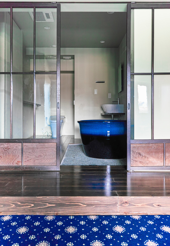 Пример оригинального дизайна: маленькая главная ванная комната с японской ванной, душем над ванной, унитазом-моноблоком, бежевыми стенами, паркетным полом среднего тона и настольной раковиной для на участке и в саду