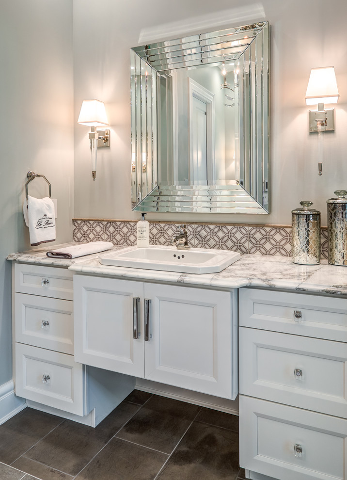 Inspiration for a medium sized traditional ensuite bathroom in Cincinnati with flat-panel cabinets, white cabinets, a built-in shower, a two-piece toilet, multi-coloured tiles, grey walls, porcelain flooring, a built-in sink, brown floors, a sliding door, mosaic tiles and white worktops.