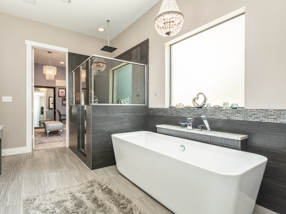 Bathroom - large craftsman master beige tile and porcelain tile porcelain tile and gray floor bathroom idea in Houston with recessed-panel cabinets, gray cabinets, a two-piece toilet, beige walls, an undermount sink, granite countertops and a hinged shower door