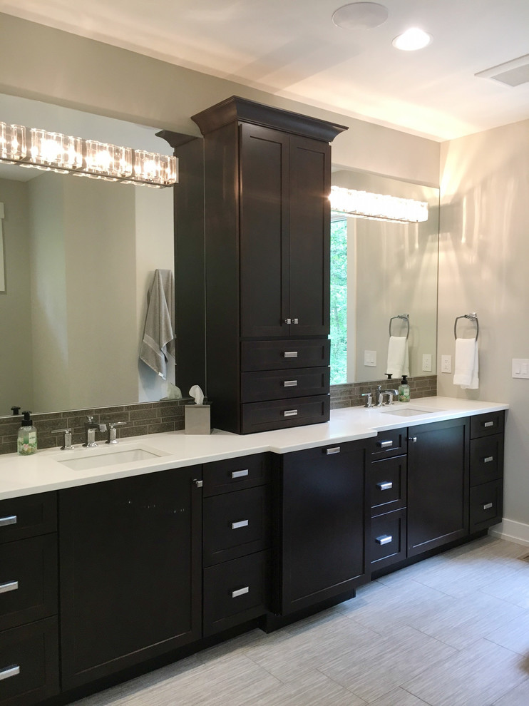 This is an example of a large modern ensuite bathroom in Other with shaker cabinets, dark wood cabinets, a freestanding bath, grey tiles, glass tiles, grey walls, ceramic flooring, a submerged sink, granite worktops and grey floors.