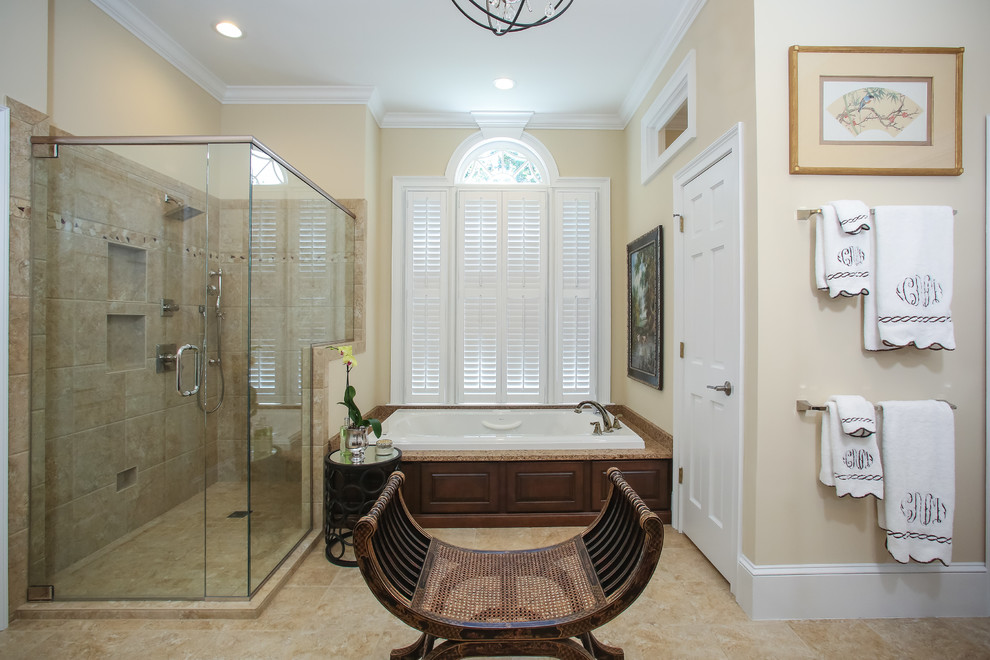 Photo of a large classic ensuite bathroom in Atlanta with raised-panel cabinets, dark wood cabinets, a built-in bath, a corner shower, ceramic tiles, beige walls, ceramic flooring, a submerged sink and granite worktops.