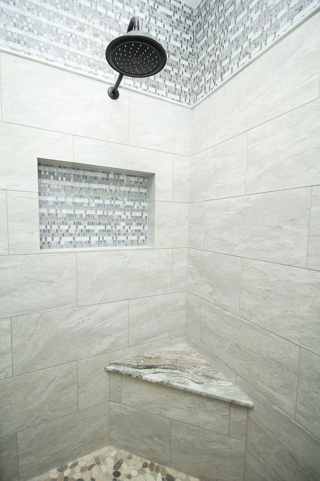 Alcove shower - mid-sized transitional master gray tile and porcelain tile porcelain tile and gray floor alcove shower idea in Houston with raised-panel cabinets, white cabinets, gray walls, an undermount sink, granite countertops and a hinged shower door