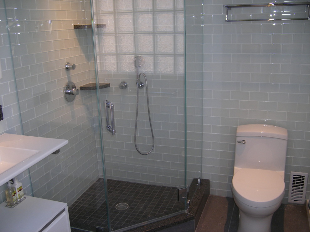 Inspiration for a mid-sized transitional 3/4 green tile and glass tile cement tile floor and gray floor corner shower remodel in DC Metro with open cabinets, white cabinets, a one-piece toilet, green walls, an integrated sink, quartz countertops and a hinged shower door