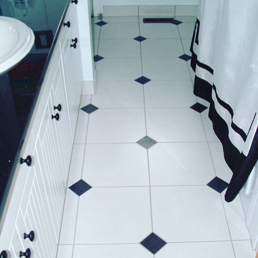 Inspiration for a medium sized classic shower room bathroom in Other with louvered cabinets, white cabinets, an alcove bath, a shower/bath combination, white walls, ceramic flooring, a built-in sink, granite worktops, white floors and a shower curtain.