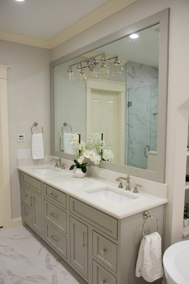 Example of a mid-sized transitional master gray tile and marble tile porcelain tile and white floor freestanding bathtub design in Orlando with recessed-panel cabinets, gray cabinets, gray walls, an undermount sink, quartzite countertops and white countertops