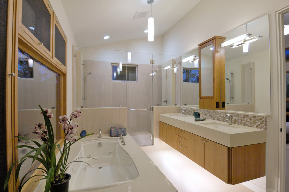 Example of a trendy gray tile alcove shower design in San Francisco with an undermount sink, flat-panel cabinets, medium tone wood cabinets and an undermount tub