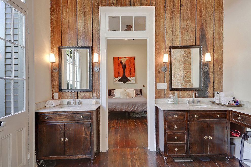 Diseño de cuarto de baño tradicional renovado con lavabo bajoencimera, puertas de armario de madera en tonos medios, paredes blancas, suelo de madera oscura y armarios con paneles lisos
