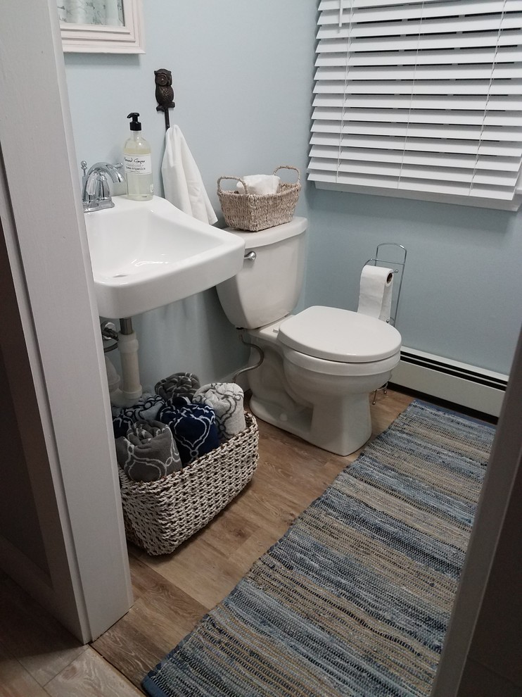 Inspiration for a small transitional 3/4 vinyl floor and brown floor bathroom remodel in Boston with a two-piece toilet, white walls and a wall-mount sink