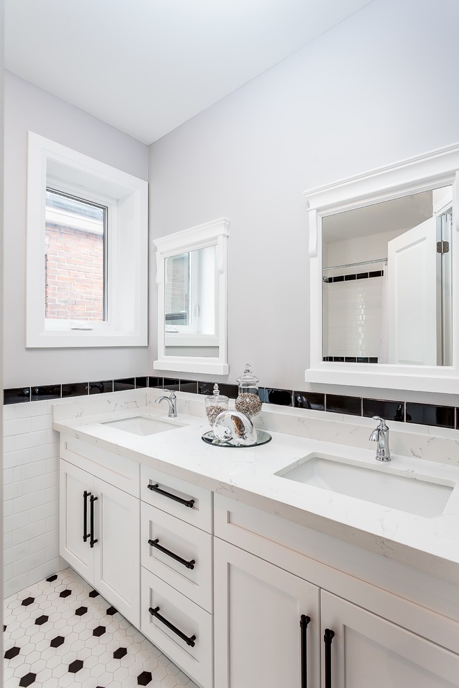 Photo of a medium sized classic bathroom in Toronto with shaker cabinets, white cabinets, a double shower, a two-piece toilet, white tiles, ceramic tiles, grey walls, ceramic flooring, a submerged sink and engineered stone worktops.