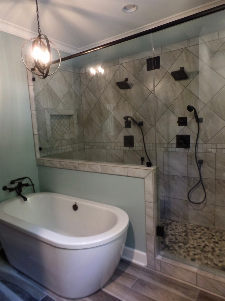 This is an example of a medium sized traditional ensuite bathroom in Other with shaker cabinets, distressed cabinets, a freestanding bath, a double shower, a two-piece toilet, grey tiles, porcelain tiles, green walls, porcelain flooring, a submerged sink and engineered stone worktops.