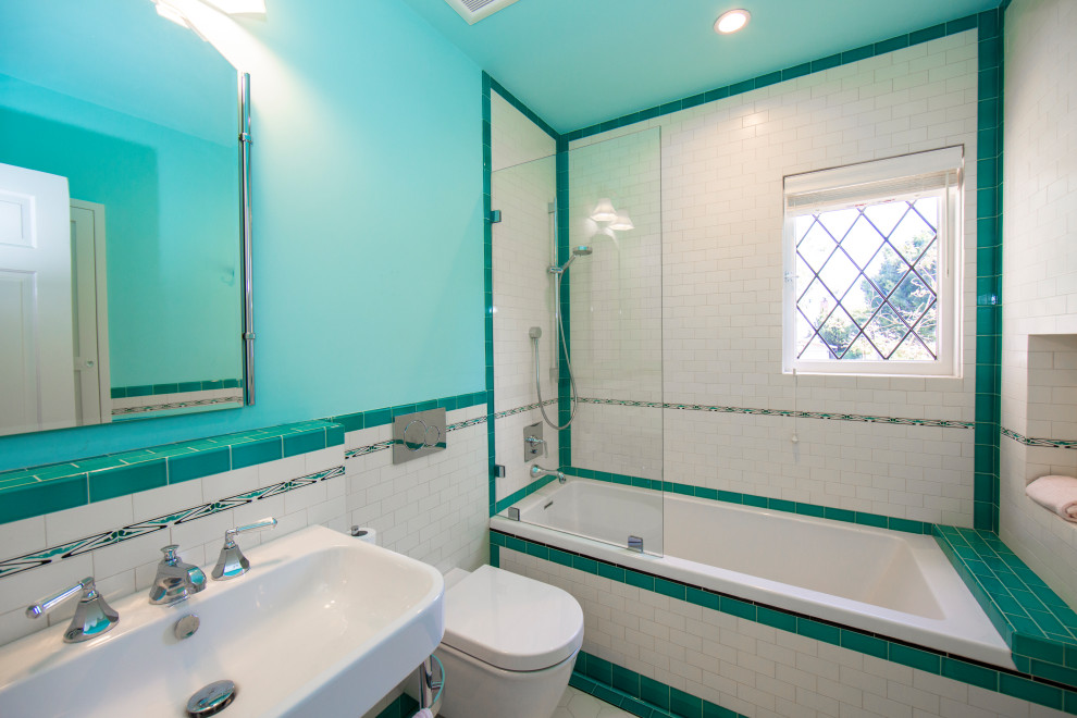Inspiration for a small traditional ensuite bathroom in Los Angeles with white cabinets, an alcove shower, a wall mounted toilet, green tiles, ceramic tiles, ceramic flooring, a pedestal sink, multi-coloured floors and a hinged door.