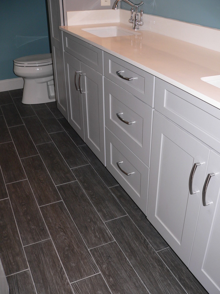 Inspiration for a mid-sized contemporary master gray tile and porcelain tile porcelain tile bathroom remodel in Philadelphia with an undermount sink, shaker cabinets, gray cabinets, quartz countertops, a two-piece toilet and blue walls