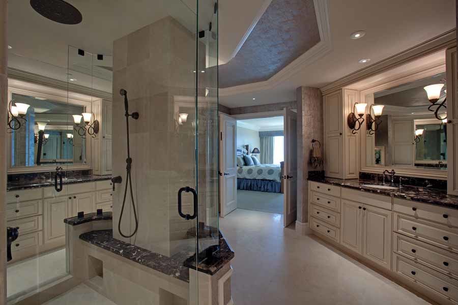 Inspiration for a medium sized classic ensuite wet room bathroom in Miami with raised-panel cabinets, white cabinets, beige walls, travertine flooring, a submerged sink, granite worktops, beige floors, a hinged door and black worktops.