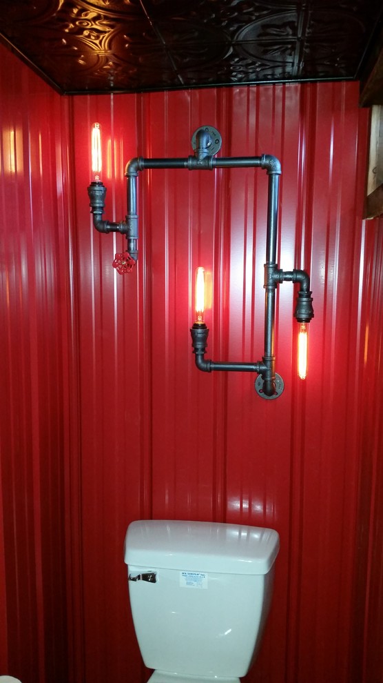 Imagen de cuarto de baño industrial de tamaño medio con sanitario de dos piezas, baldosas y/o azulejos grises, paredes rojas, suelo de madera oscura y lavabo sobreencimera