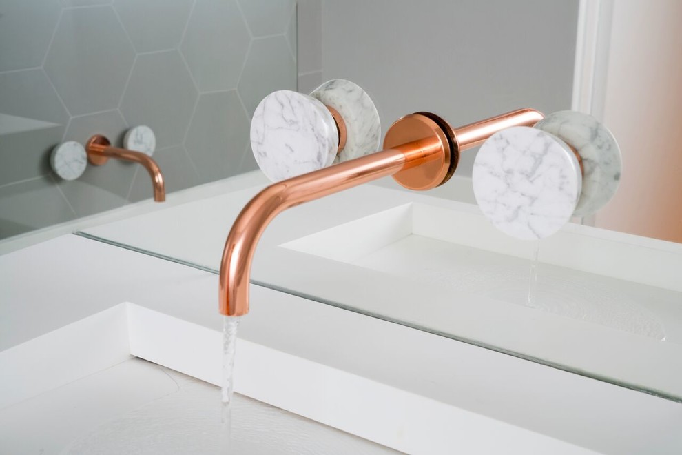 Inspiration for a contemporary bathroom remodel in London with a wall-mount sink