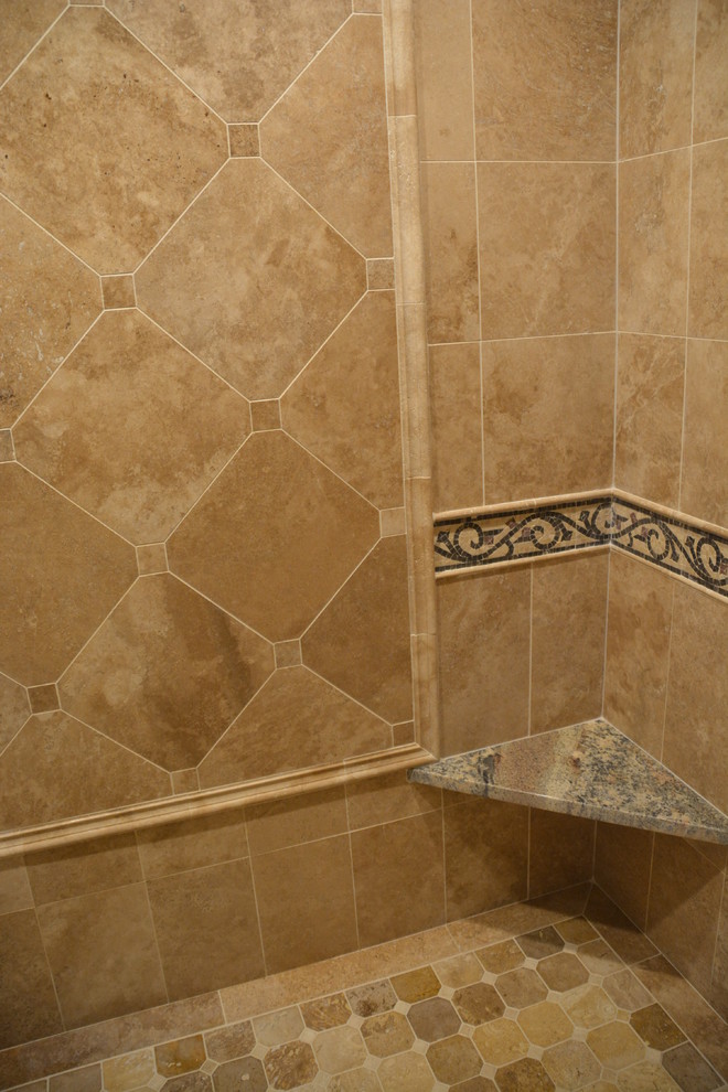 Huge tuscan master beige tile and stone tile limestone floor and beige floor bathroom photo in Milwaukee with raised-panel cabinets, medium tone wood cabinets, a two-piece toilet, beige walls, granite countertops and a hinged shower door