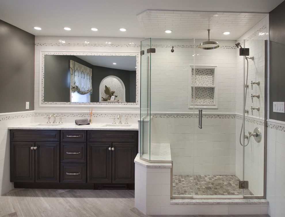 Bathroom - large transitional master white tile and ceramic tile porcelain tile bathroom idea in New York with raised-panel cabinets, gray cabinets, a one-piece toilet, gray walls, an undermount sink and quartz countertops