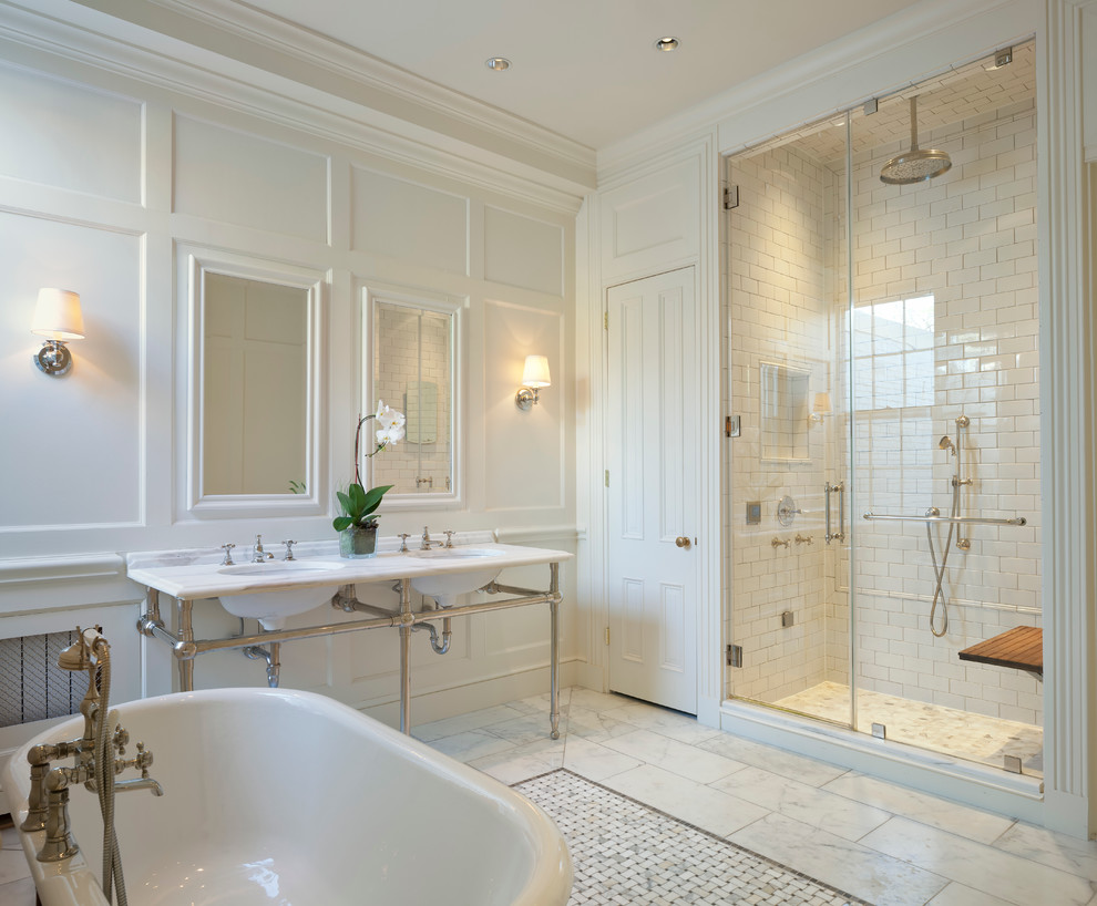 Inspiration for a timeless master white tile and ceramic tile marble floor freestanding bathtub remodel in DC Metro with white walls, marble countertops and a console sink