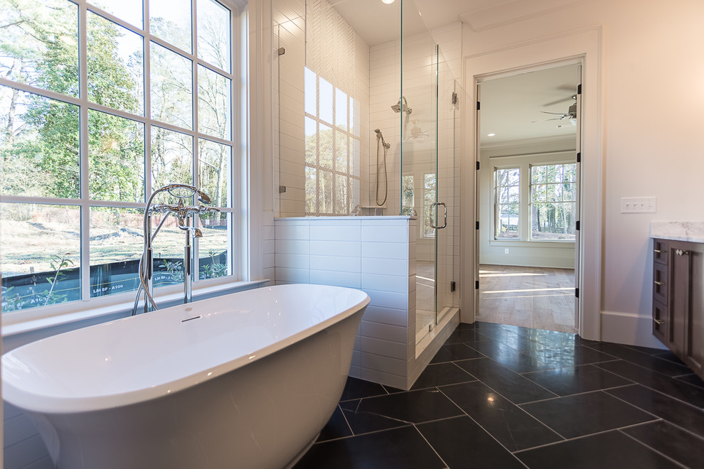Bathroom - mid-sized transitional 3/4 white tile and ceramic tile porcelain tile and black floor bathroom idea in Atlanta with recessed-panel cabinets, dark wood cabinets, white walls, an undermount sink, marble countertops and a hinged shower door