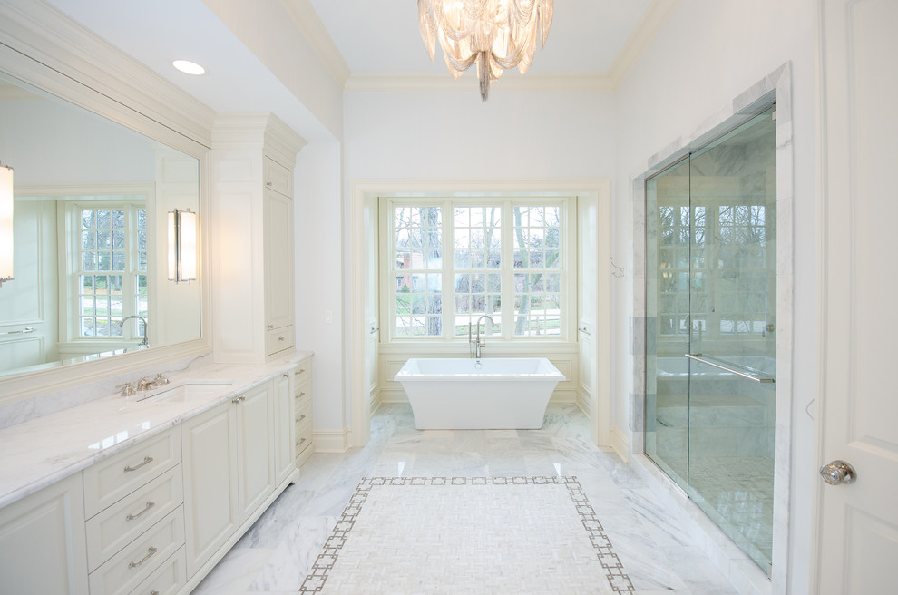 Photo of a medium sized classic ensuite bathroom in Chicago with white cabinets, white tiles, white walls, marble worktops, multi-coloured floors and white worktops.
