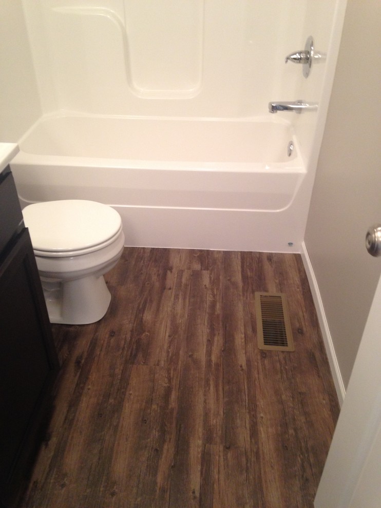 Immagine di una stanza da bagno chic di medie dimensioni con ante in stile shaker, ante in legno bruno e pavimento in vinile