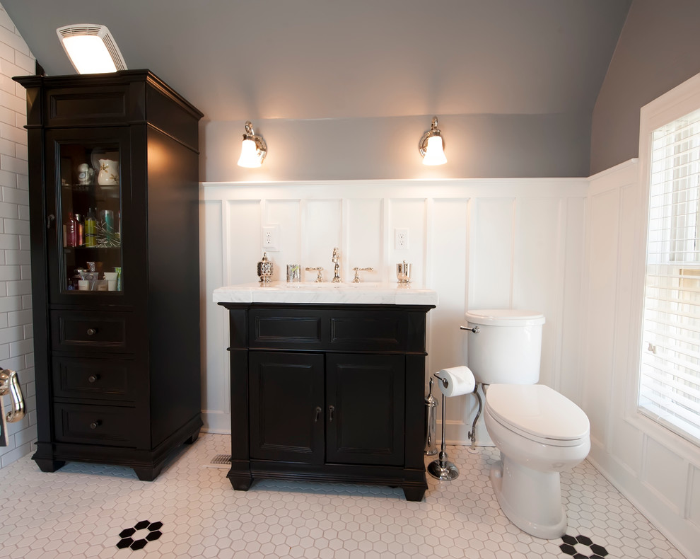 Photo of a medium sized contemporary ensuite bathroom in Columbus with recessed-panel cabinets, black cabinets, a freestanding bath, a corner shower, white tiles, ceramic tiles, grey walls, porcelain flooring, a built-in sink and marble worktops.