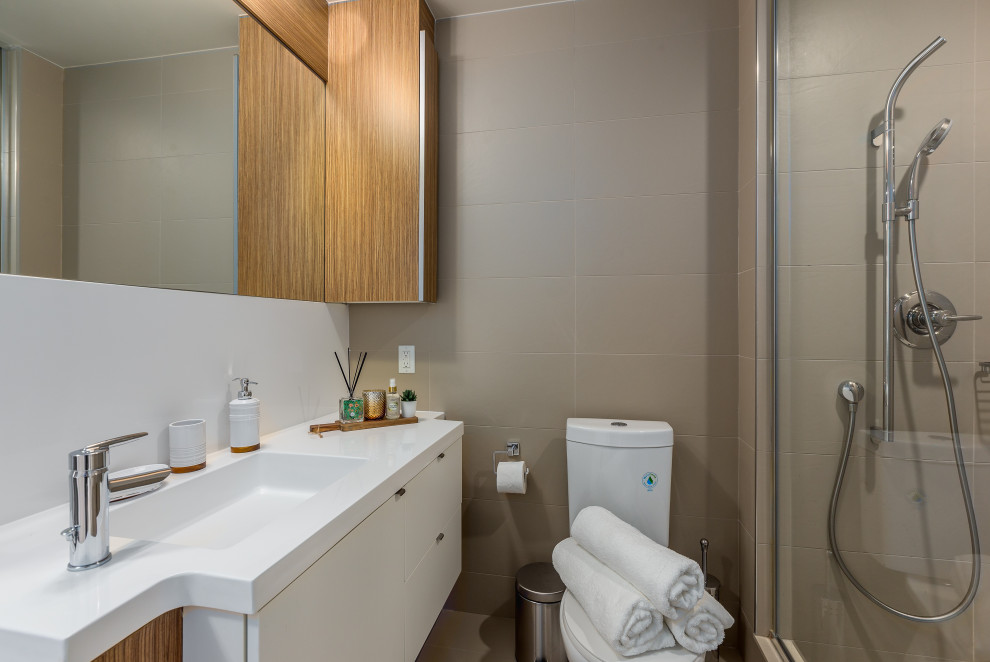 This is an example of a small contemporary shower room bathroom in Toronto with flat-panel cabinets, white cabinets, an alcove shower, grey tiles, porcelain tiles, porcelain flooring, an integrated sink, grey floors, white worktops, a single sink and a floating vanity unit.