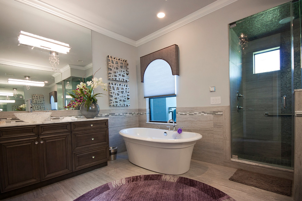 Large traditional ensuite bathroom in Miami with raised-panel cabinets, dark wood cabinets, a freestanding bath, a corner shower, metal tiles, beige walls, light hardwood flooring, a vessel sink, quartz worktops and a hinged door.