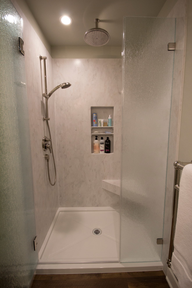 Mid-sized beach style 3/4 multicolored tile and glass tile vinyl floor alcove shower photo in Seattle with recessed-panel cabinets, green cabinets, a two-piece toilet, gray walls, an integrated sink and solid surface countertops