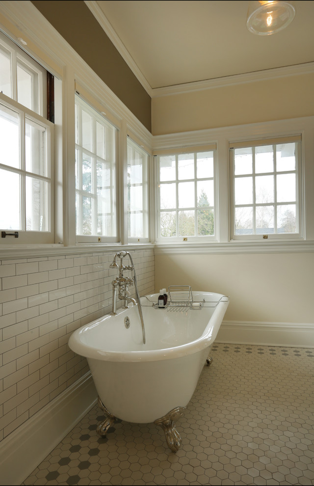 Example of a large classic master beige tile and porcelain tile porcelain tile claw-foot bathtub design in Portland with brown walls