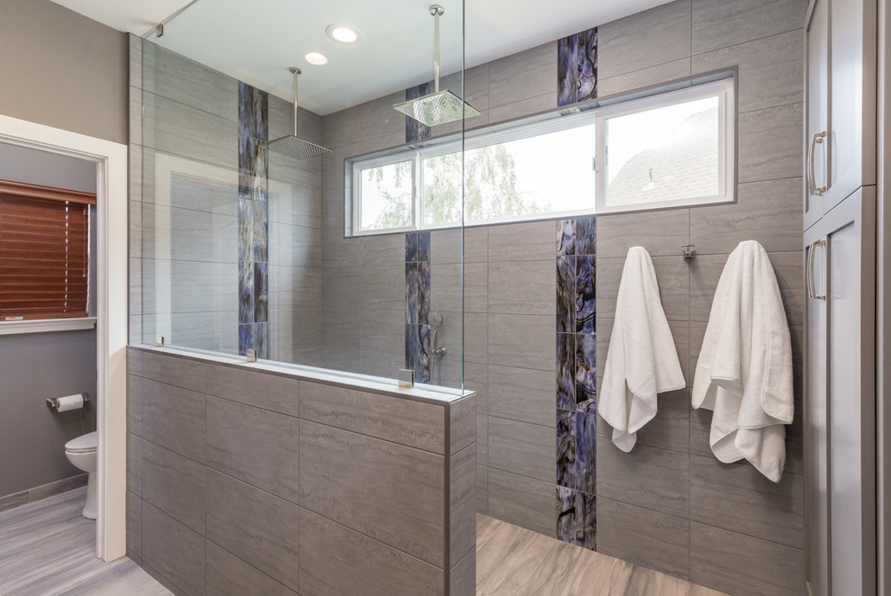 Photo of a large modern ensuite bathroom in San Francisco with grey cabinets, a double shower, blue tiles, grey tiles, porcelain tiles, grey walls, porcelain flooring, a submerged sink, marble worktops, brown floors, an open shower and grey worktops.