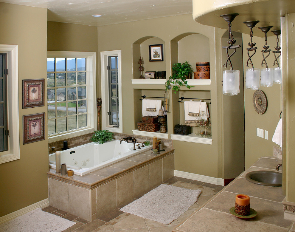Exemple d'une très grande salle de bain principale chic avec un lavabo posé, un plan de toilette en carrelage, une baignoire posée, un carrelage beige, des carreaux de porcelaine, un mur beige et un sol en carrelage de porcelaine.