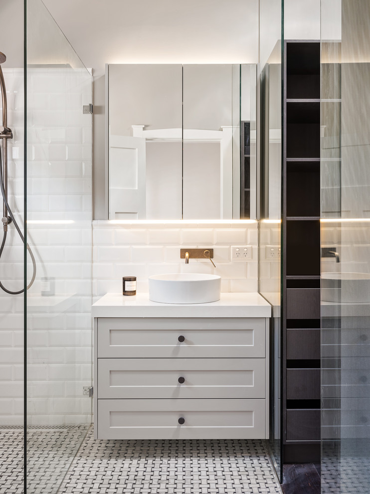 Design ideas for a medium sized traditional ensuite bathroom in Sydney with shaker cabinets, black cabinets, a freestanding bath, a shower/bath combination, a one-piece toilet, white tiles, ceramic tiles, black walls, mosaic tile flooring, a vessel sink, engineered stone worktops, grey floors, an open shower and white worktops.