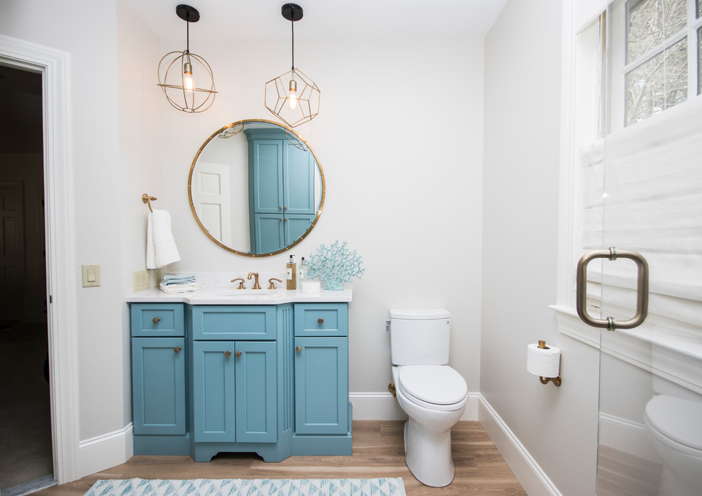 Large elegant master beige tile and porcelain tile vinyl floor and brown floor corner shower photo in Providence with furniture-like cabinets, blue cabinets, a two-piece toilet, gray walls, an undermount sink, quartz countertops and a hinged shower door
