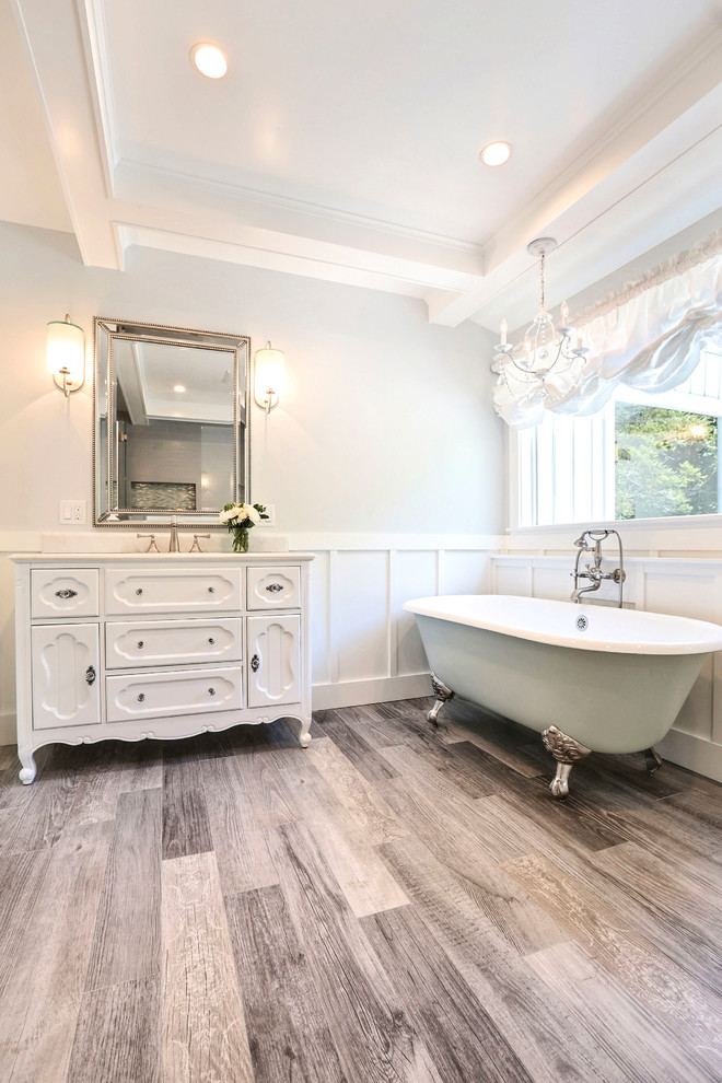 This is an example of a large shabby-chic style ensuite bathroom in San Francisco with freestanding cabinets, white cabinets, a claw-foot bath, an alcove shower, a two-piece toilet, grey tiles, ceramic tiles, blue walls, porcelain flooring, a submerged sink, engineered stone worktops, grey floors, a hinged door and white worktops.