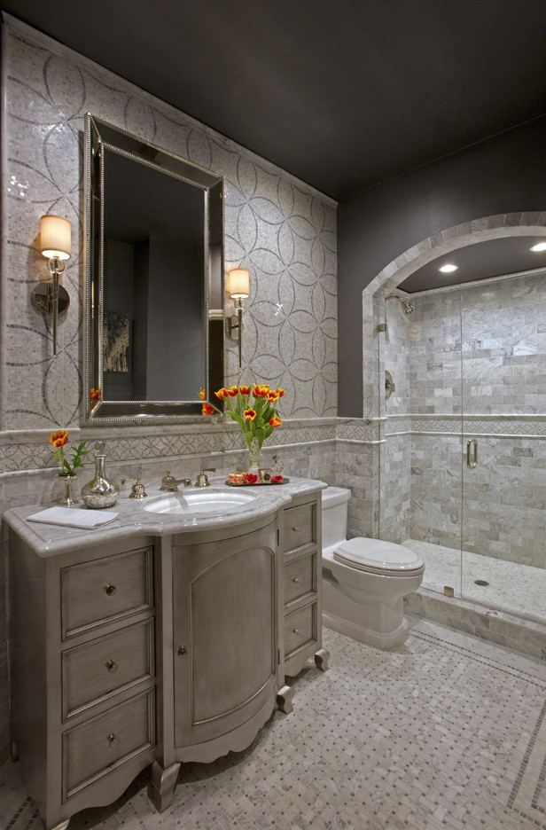 Inspiration for a medium sized traditional ensuite bathroom in Orange County with freestanding cabinets, grey cabinets, an alcove shower, grey tiles, white tiles, mosaic tiles, grey walls, mosaic tile flooring, a submerged sink, marble worktops, multi-coloured floors, a hinged door and a one-piece toilet.