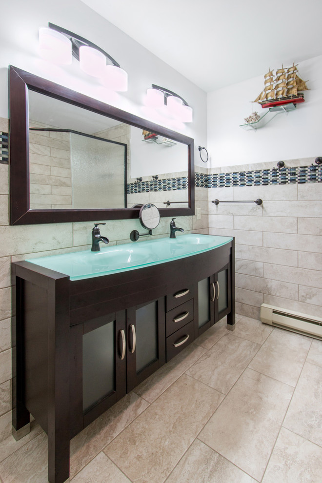 This is an example of a medium sized contemporary ensuite bathroom in Milwaukee with recessed-panel cabinets, dark wood cabinets, an alcove shower, a two-piece toilet, black tiles, blue tiles, white tiles, mosaic tiles, white walls, ceramic flooring, an integrated sink, glass worktops, beige floors and an open shower.